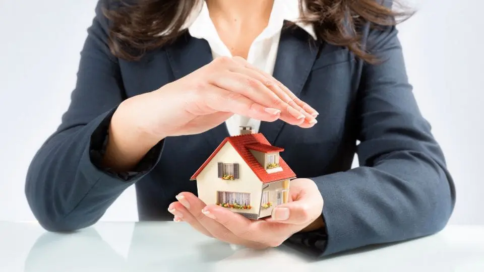 Businesswoman Protecting a Small Model House