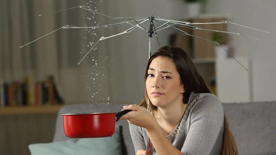 Woman Holding A Broken Umbrella And A Pot