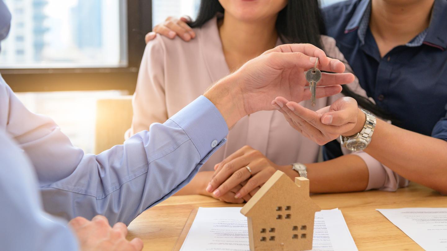 Agent Handing Keys to Couple
