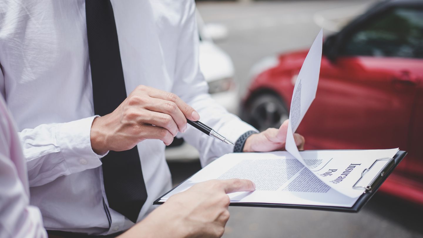 Person Reviewing and Signing Insurance Papers