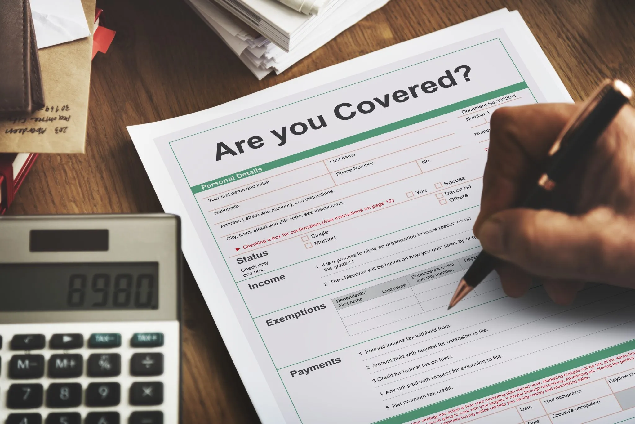 Filling Out Insurance Coverage Form With Pen