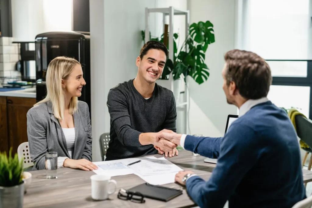 Insurance Agent Shaking Hands With Clients