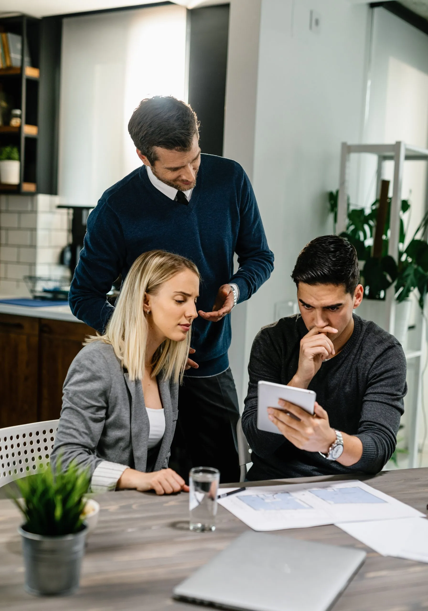 Insurance Consultant Reviewing Insurance Documents With Clients
