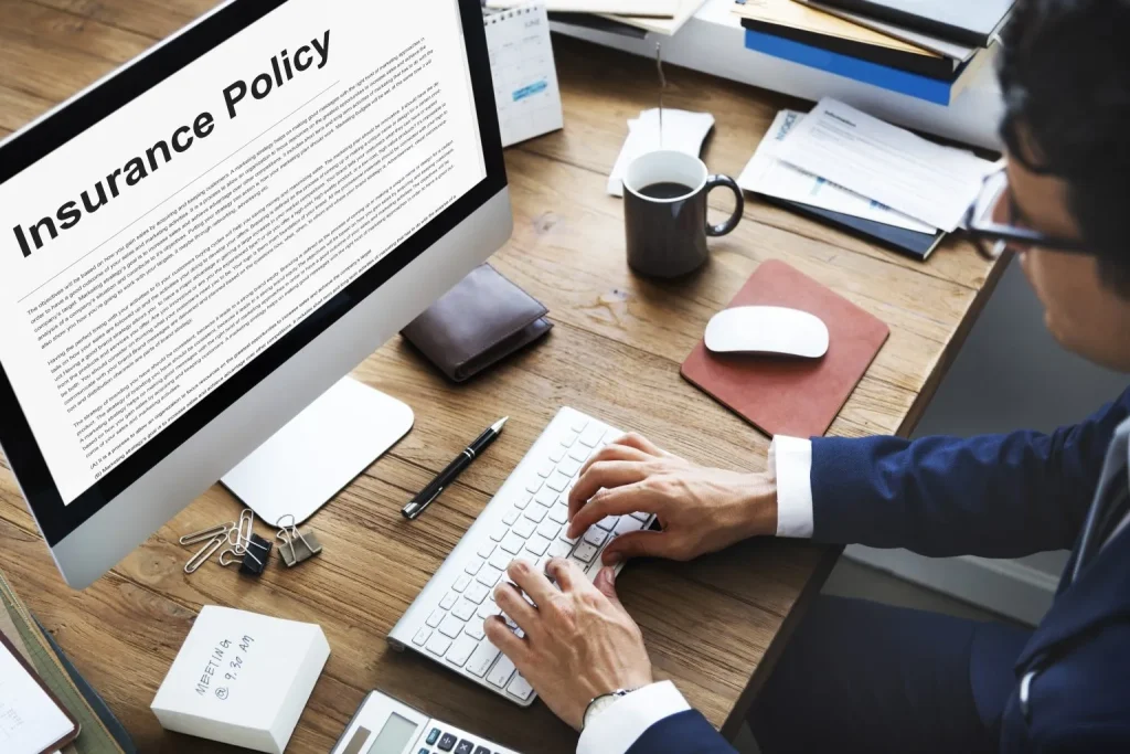 Reviewing Insurance Policy On Desktop Computer Screen